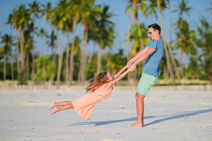 Little girl and father during tropical beach vacation stock photo containing