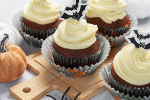 Cupcakes with bat decorations celebrating halloween spooky seaso, a Food & Drink Photo by Olena Rudo