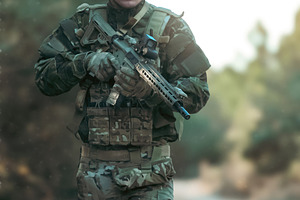 Soldier walking in the forest holding a rifle during airsoft game, a Sports & Recreation Photo by Antonio Gravante Market