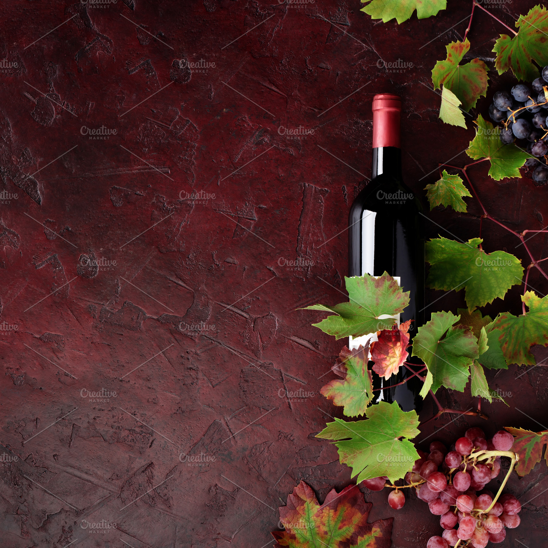 Red Wine Bottle with Grapes and Vine Leaves on Rustic Background, a Food & Drink Photo by Natalia Klenova's Shop