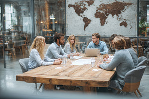 Diverse team brainstorming around wo, a Photo by Pixeness Studio