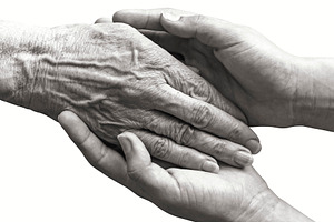 Young hands holding old woman hand, a Person Photo by BOOCYS