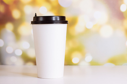 White paper cup of coffee to go containing addiction, background, and blurred