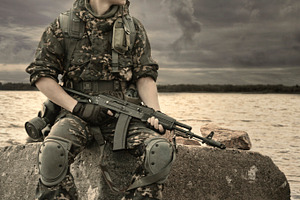 Man with gun featuring toned image, sunrise, and sunset