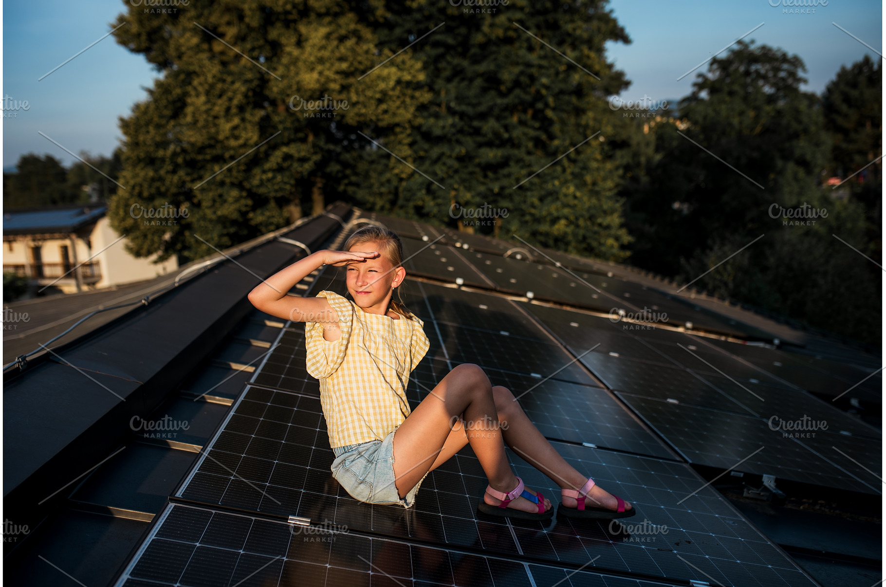 Girl sitting on roof with solar, a Technology Photo by HalfPoint