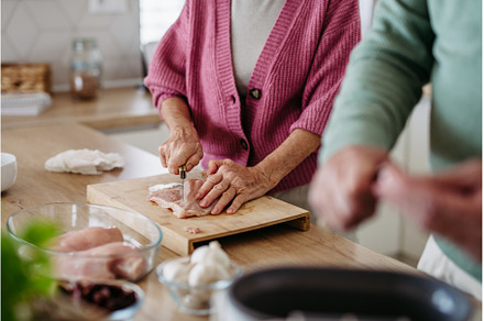 Senior couple cooking together in, a Person Photo by HalfPoint