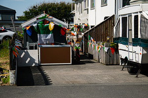 Decorated yard celebrating Irish days in Akranes Iceland with flags and colorfu, a Photo by AS photostudio