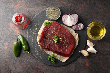 Concept of tasty food with raw beef steak, top view, a Food & Drink Photo by AtlasStudio PRO