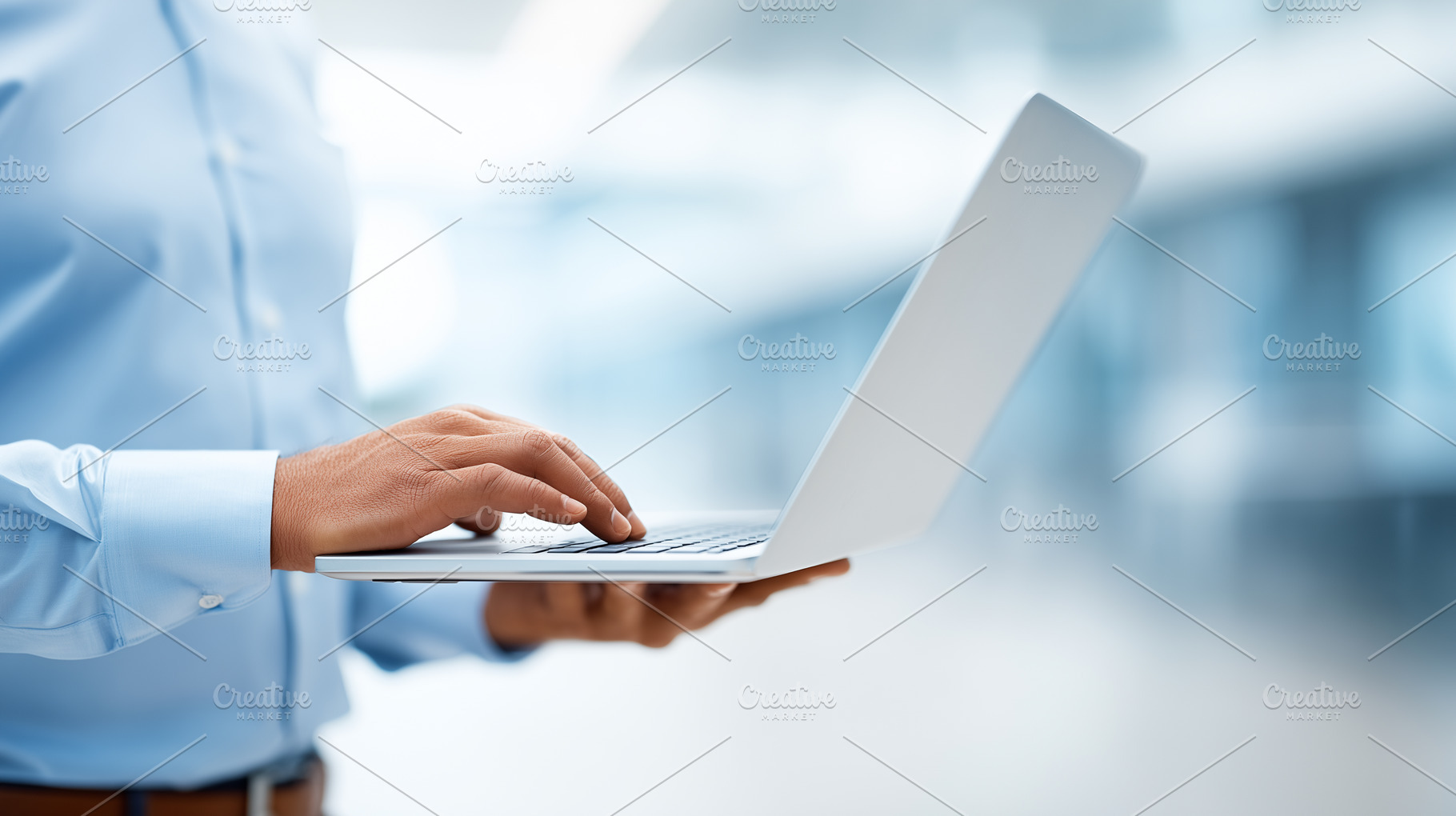Man in a blue shirt using a laptop, a Business Photo by MistyDay