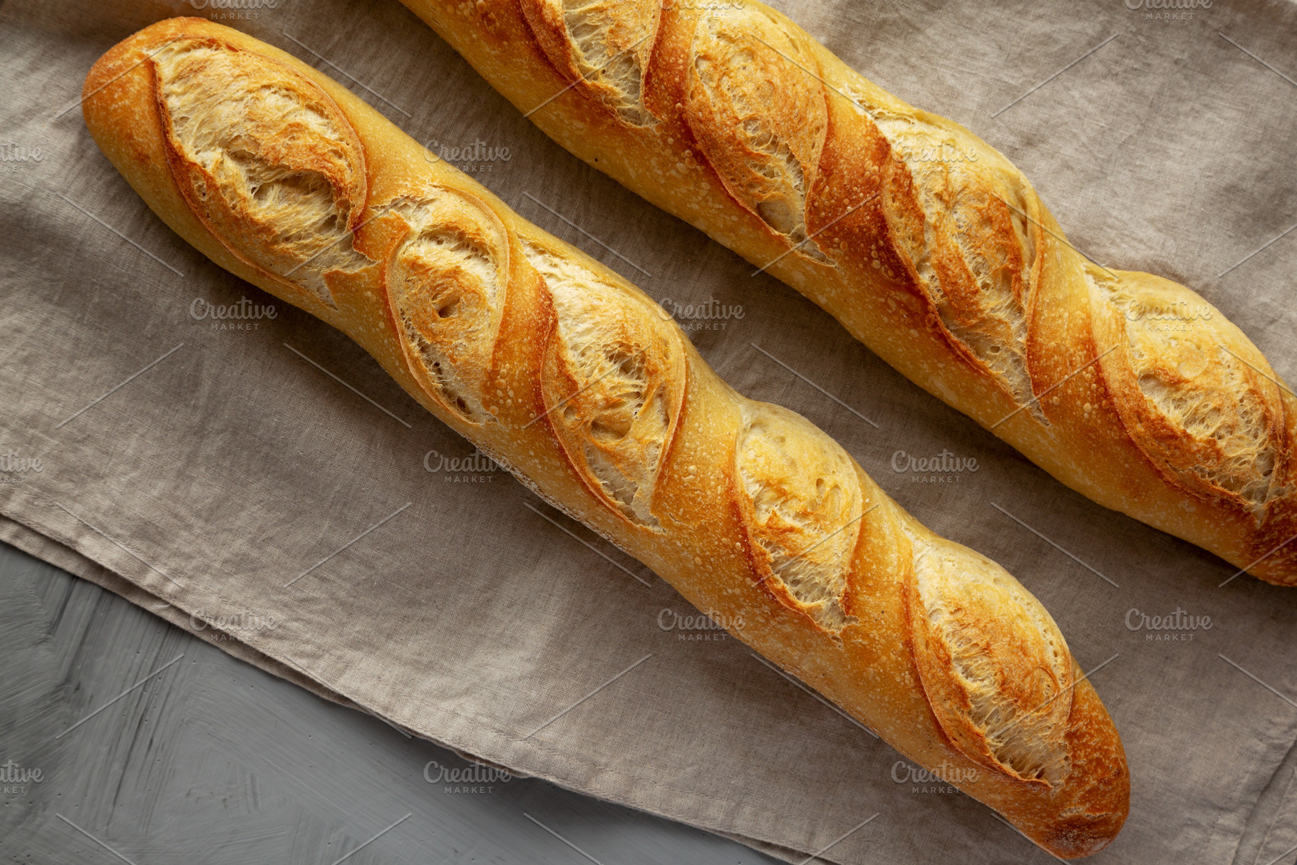 Homemade French Bread Baguette on a gray background, top view., a Food & Drink Photo by LiudmylaChuhunova