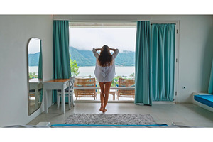 Woman enjoying morning lake view, a Person Photo by Goinyk