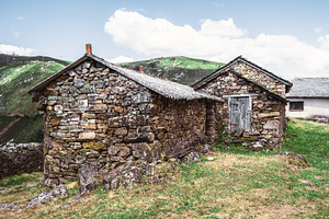 Rustic stone huts in mountain meadow, an Architecture Photo by SkyNext