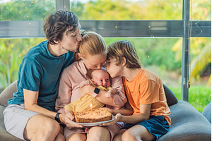 Happy family celebrating their, a Person Photo by Elizaveta Galitskaya