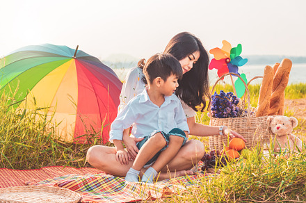 Beautiful Asian mother and son doing picnic and in Easter summer, a Person Photo by Ministocker