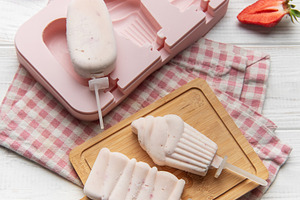 Making homemade strawberry ice pops with silicone mold, a Food & Drink Photo by Olena Rudo