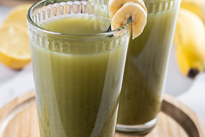 Green smoothie with spinach,banana, apple, and lemon on white ma, a Food & Drink Photo by etorres69