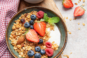 Healthy breakfast granola bowl with fresh berries, a Food & Drink Photo by Olena Rudo