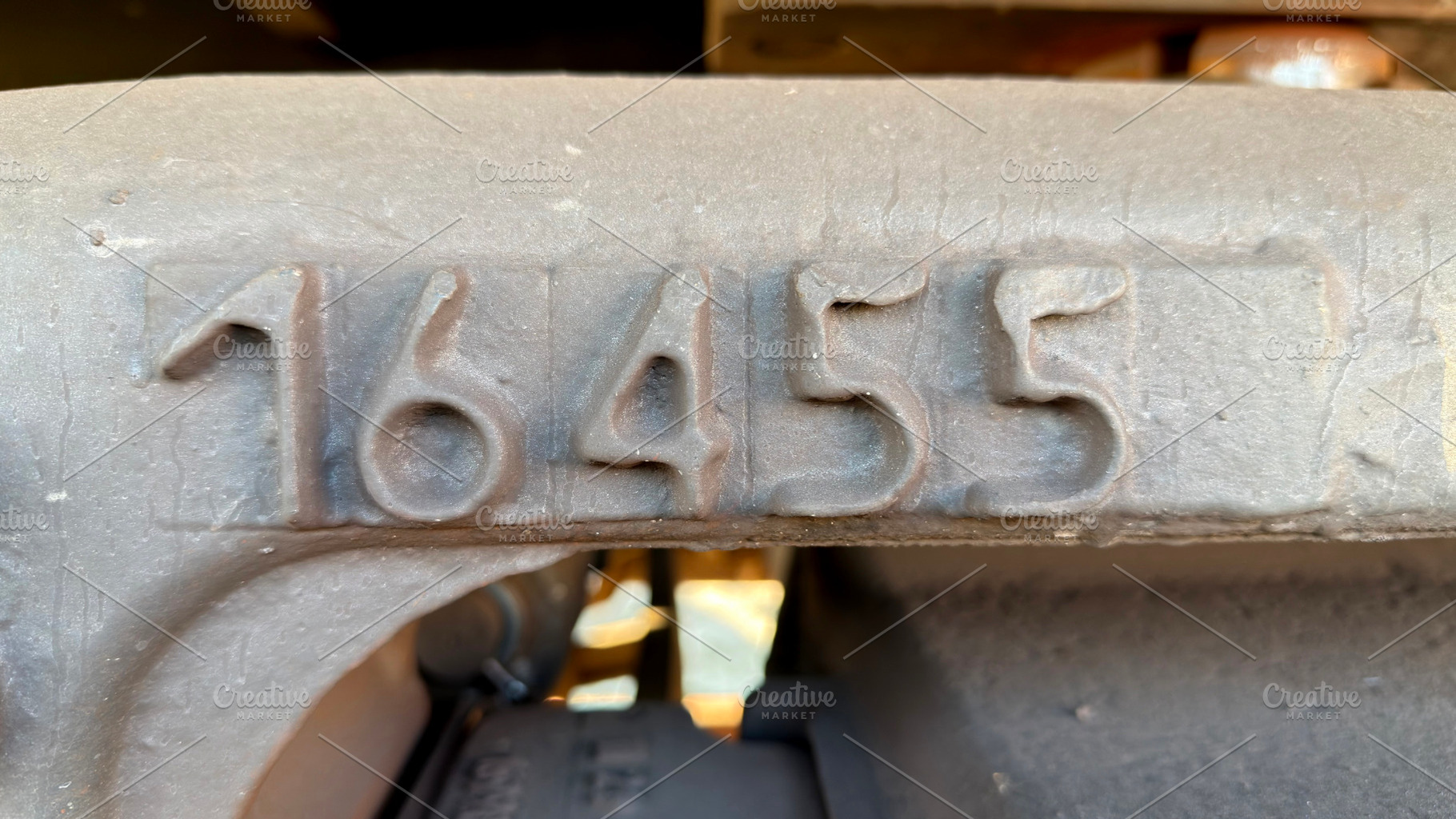 A close-up view of a metal surface with embossed numbers 16455, showcasing indu, an Industrial Photo by Textures & Backgrounds