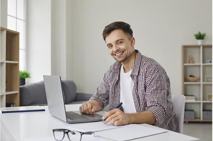 Portrait of happy man sitting at, a Technology Photo by StudioRomantic