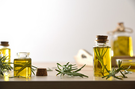 Rosemary essence in jars with fresh twigs on wooden isolated, a Health & Medical Photo by Davizro's Market
