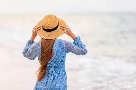 Beautiful teenager girl on tropical seashore at sunset. Beautiful little girl i
