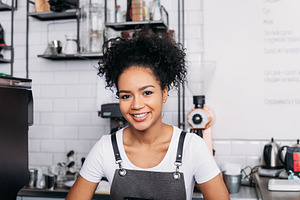 Close-up of a young smiling barista, a Person Photo by Artem Varnitsin