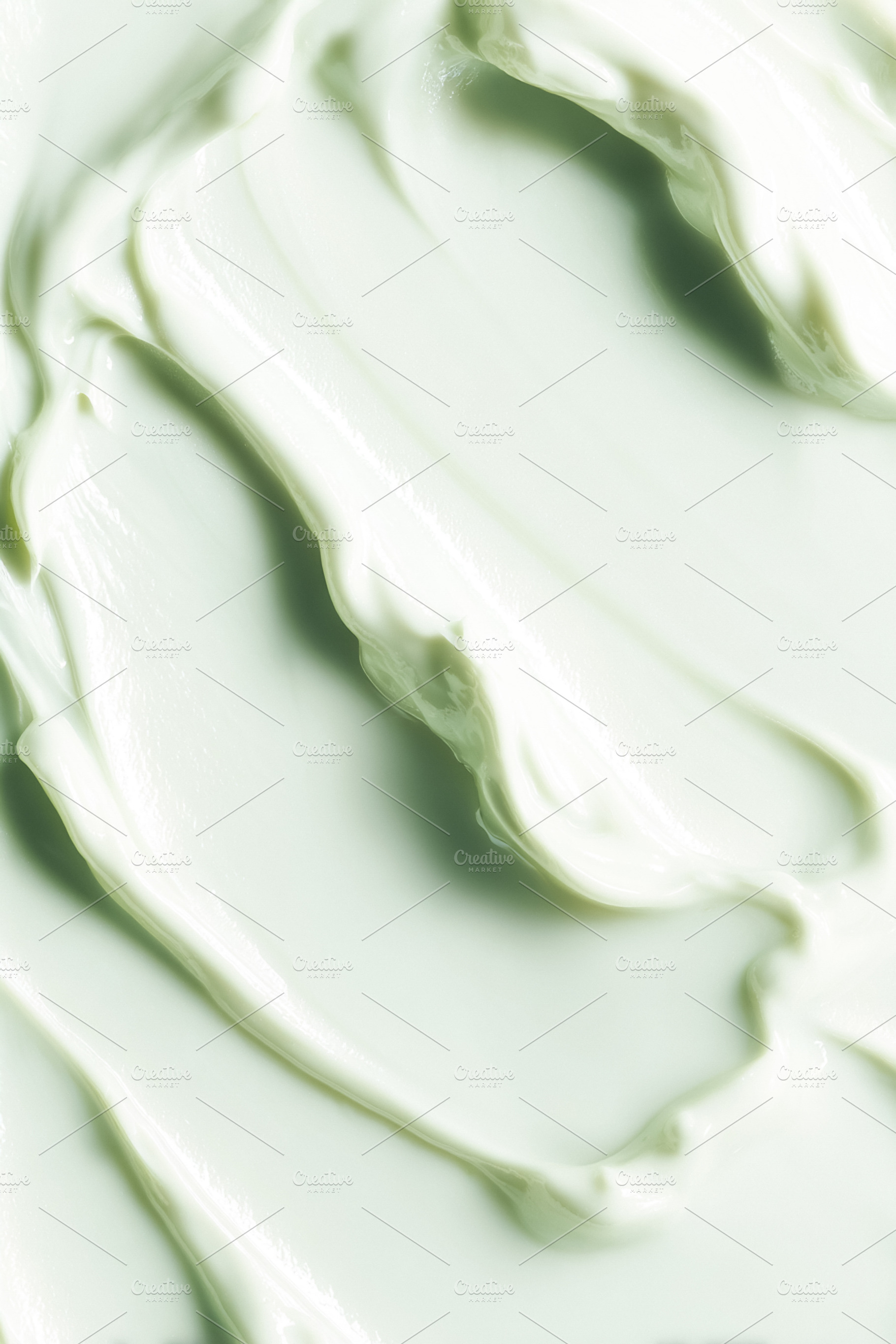 Smooth green skincare cream texture background spreading on a su, a Photo by Studio ANNA