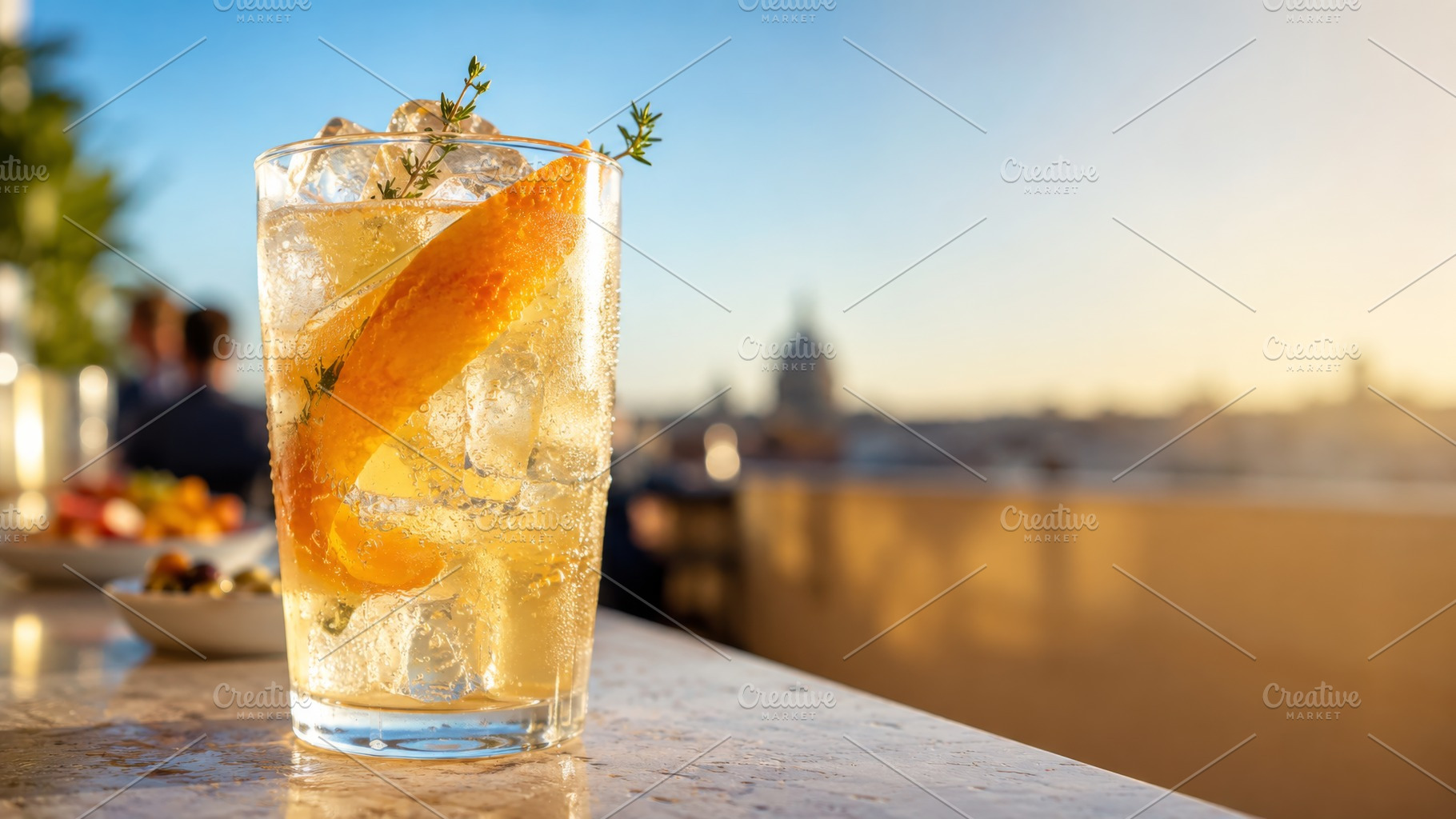 Citrus daycap drink with ice, orange peel and thyme on rooftop b, a Photo by Dvoevnore photos