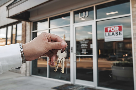 A hand holds keys in front