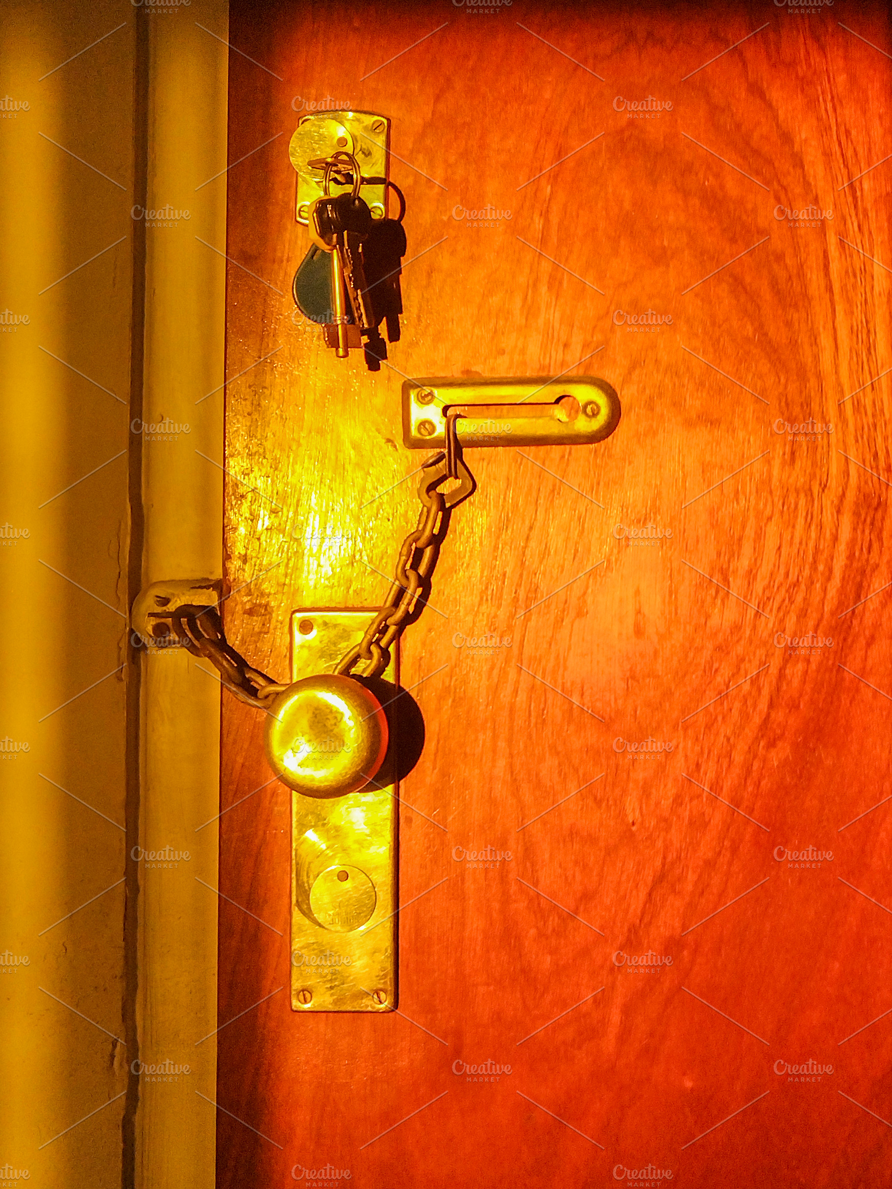 Warm toned door handle casting shadow, an Architecture Photo by DanFLCreativo