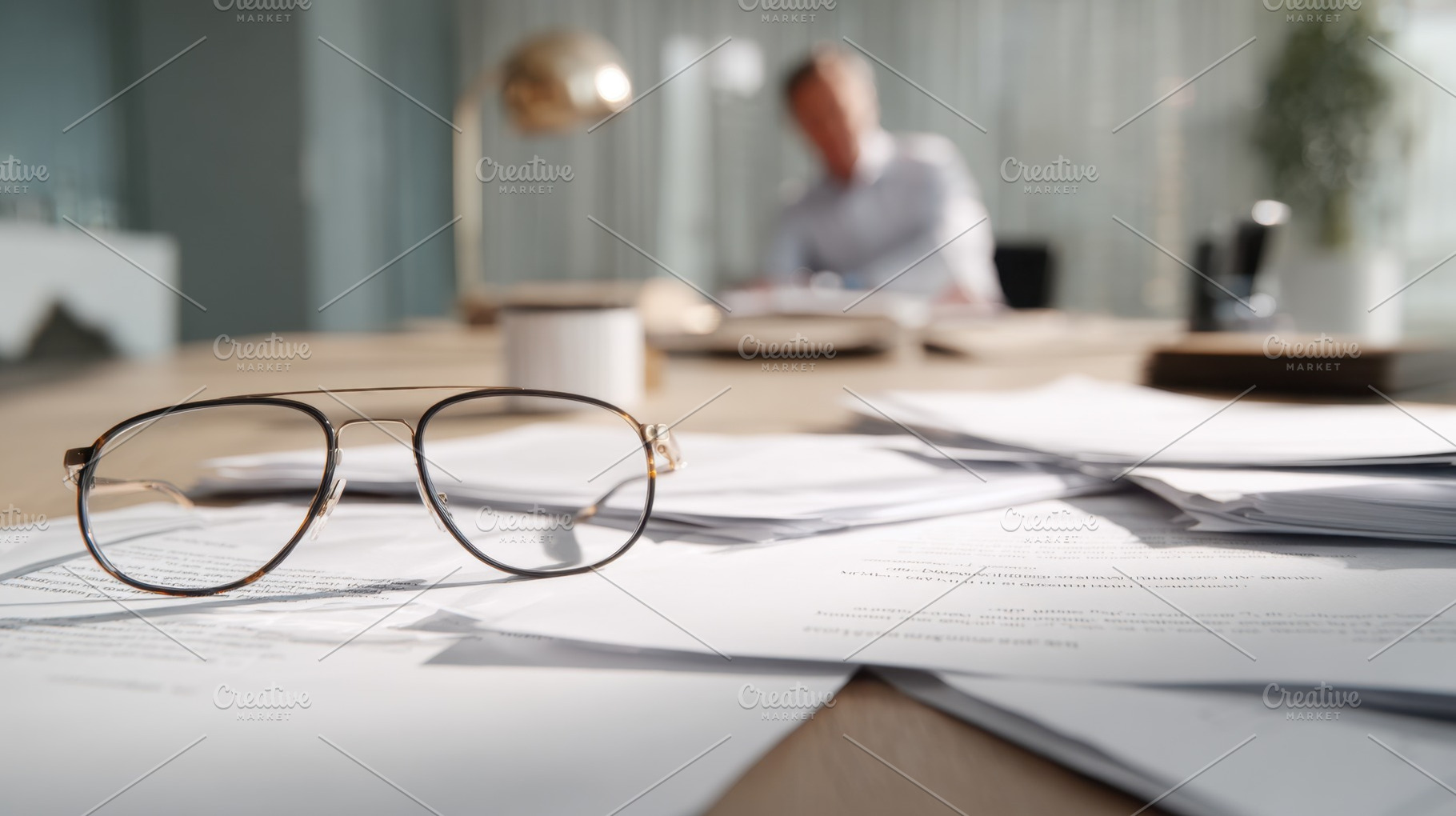 Glasses on papers in a busy office, a Photo by Beautiful things