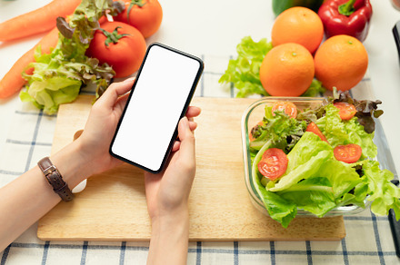 Woman hand holding a smartphone blan