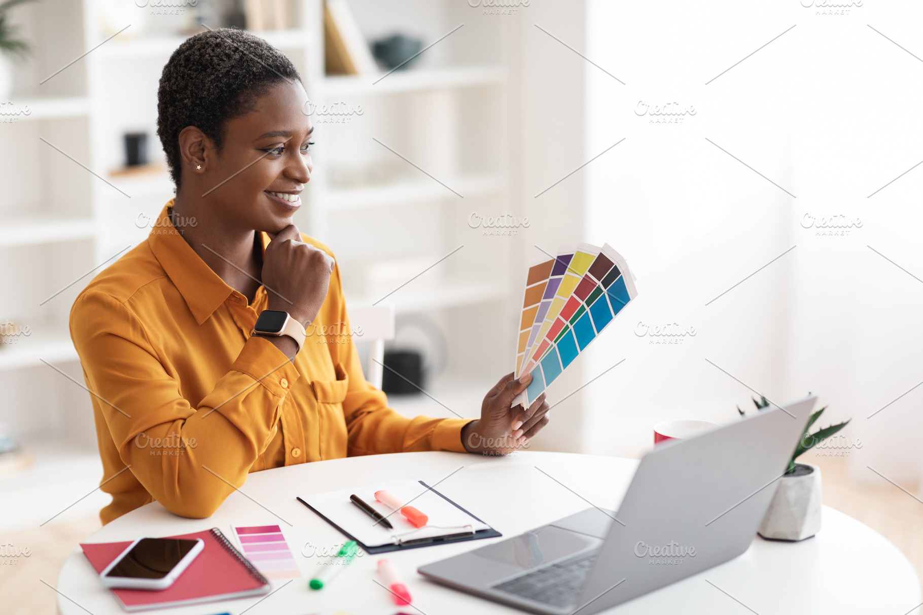 Creative young black woman designer working on laptop, a Photo by Prostock-Studio