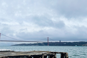 Lisbon harbor with red suspension bridge and weathered pier over calm sea and c, a Photo by AS photostudio