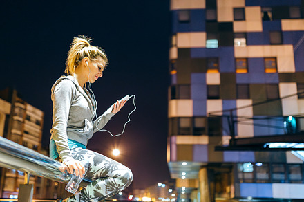 Concentrated young blonde woman looking streaming training video on smartphone, a Technology Photo by davidpereiras