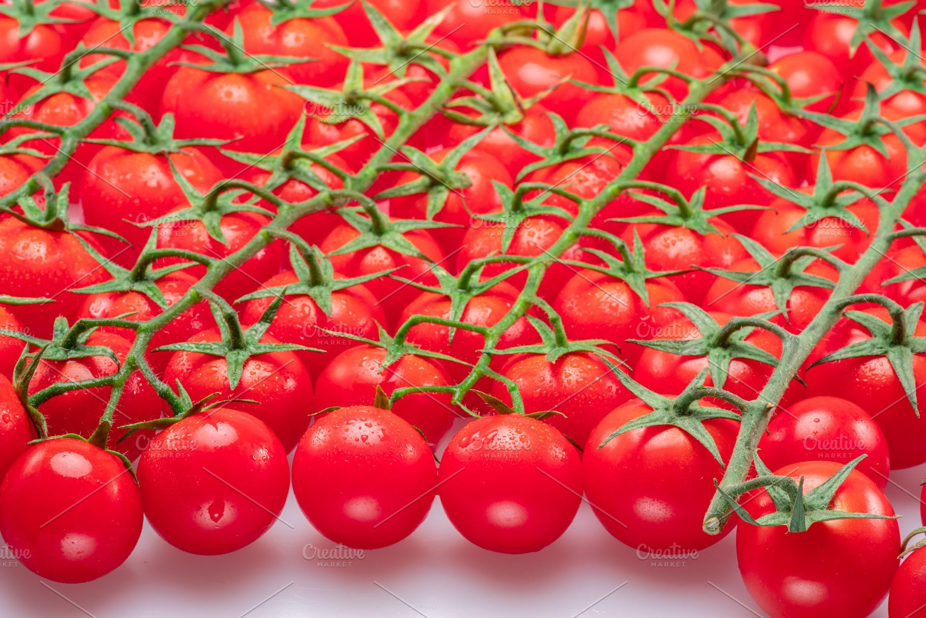 Lot of red cherry tomato branches covered with small water drops, a Food & Drink Photo by Volff