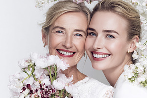 Mother and adult daughter smiling together, celebrating generati, a Photo by Studio ANNA