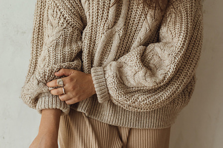 Stylish woman in cozy knitted sweater posing with chrysanthemum, a Person Photo by Sonjachni
