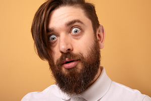 Close-up portrait of a bearded man with wide eyes and an astonis, a Person Photo by Ales Munt