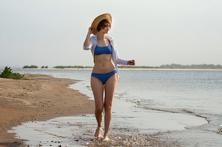 Girl in bikini walks on beach, a Person Photo by Elena Vagengeim