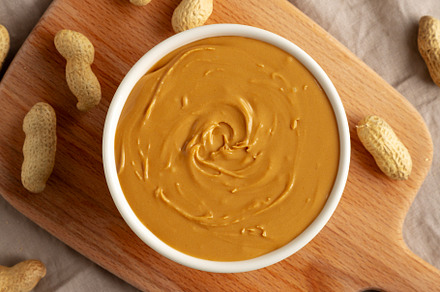 Organic Peanut Butter in a Bowl, top view. Flat lay, overhead.