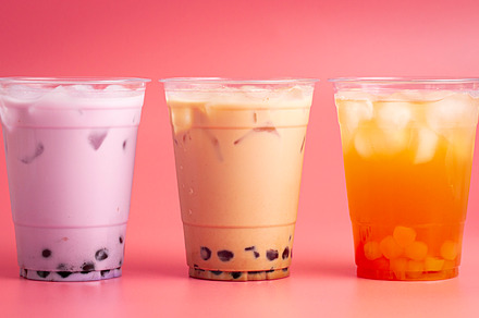 Three Different Types of Boba Tea on a Bright Pink Background