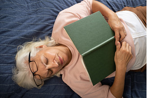 senior woman lying on sofa and