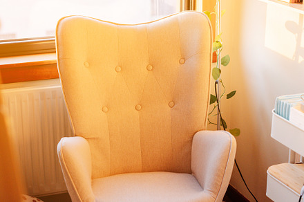 A rocking chair on a baby room at sunset