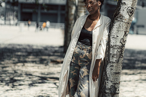 Woman Leaning by Urban Tree, a Person Photo by SkyNext