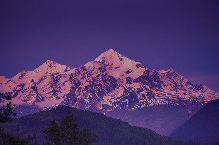 Sunset evening view over the snowy mountain peak stock photo containing, a Nature Photo by Goinyk