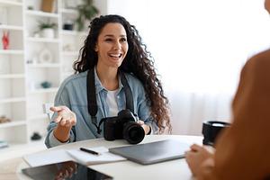 Female Photographer Having Job Interview Talking To Lady In Office, a Photo by Prostock-Studio