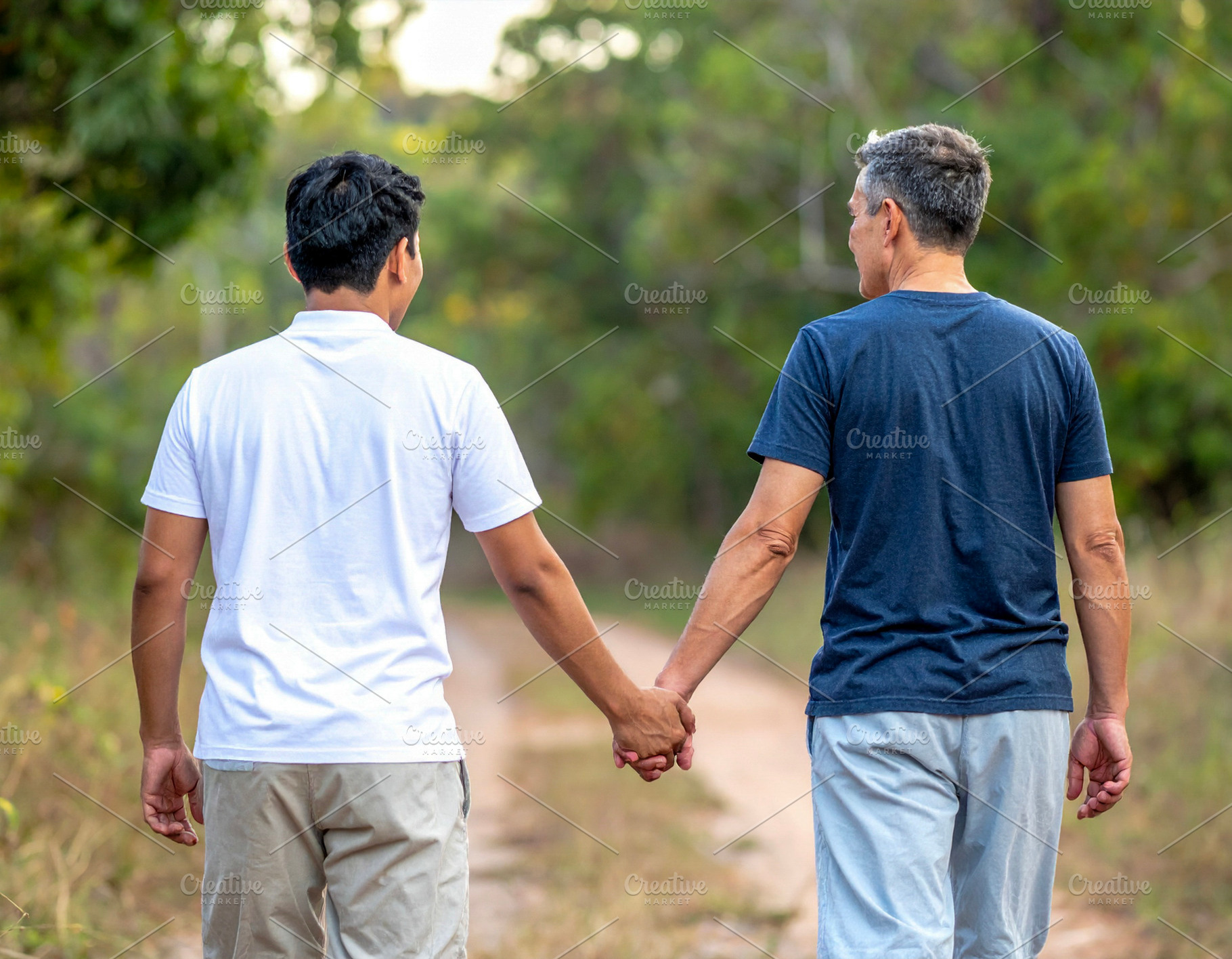 Back view of two men holding hands outdoors, a Technology Photo by DanFLCreativo