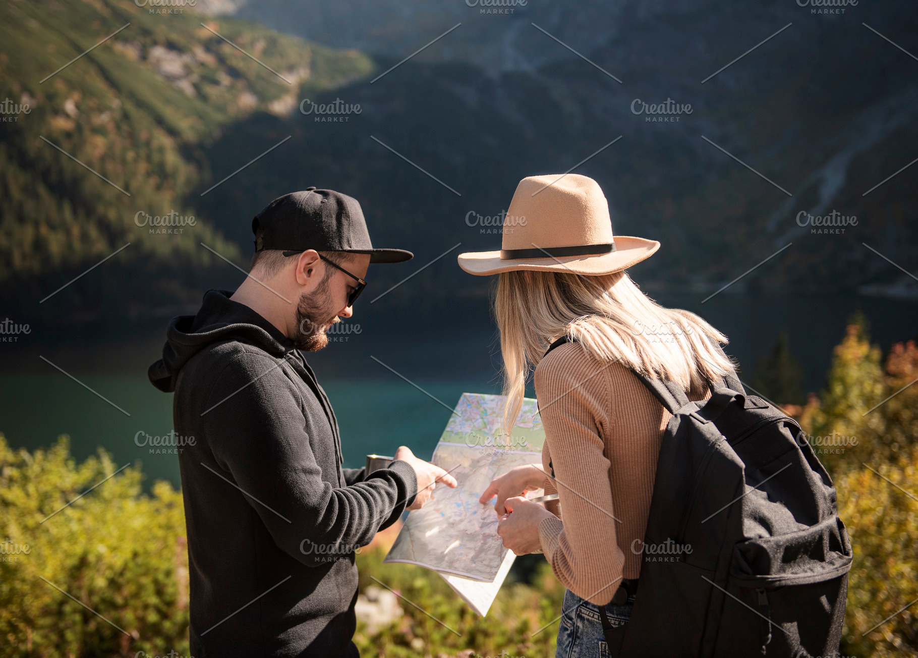 Young tourist couple, man and woman, on hiking path in mountains, a Person Photo by Olena Rudo