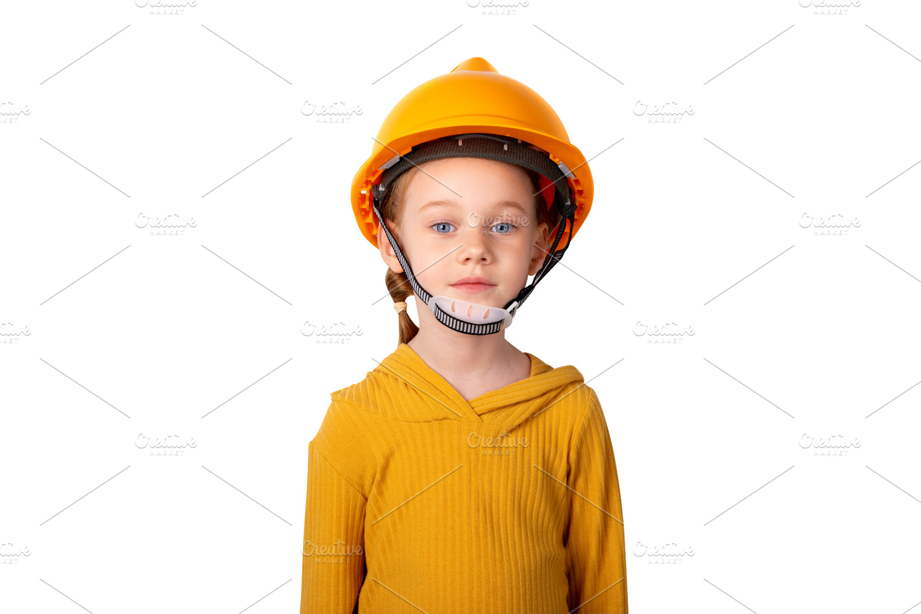 Young girl in yellow shirt and orange safety helmet standing aga, a Person Photo by Ales Munt